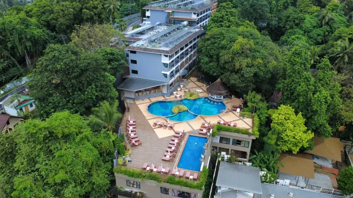 the resort nestled in the green hills of the coast